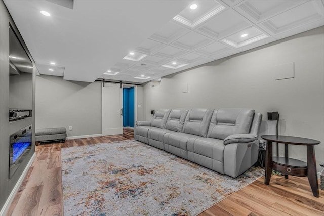 living room with a barn door, recessed lighting, wood finished floors, and coffered ceiling