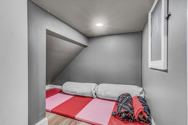 bedroom with recessed lighting, baseboards, and wood finished floors