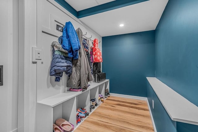 mudroom featuring wood finished floors and baseboards