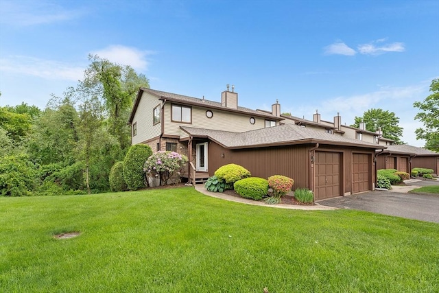 25 Ash Ln Unit 25, Agawam, MA 01001 - view of front facade with a chimney, a front yard, a garage, asphalt driveway, and a shingled roof