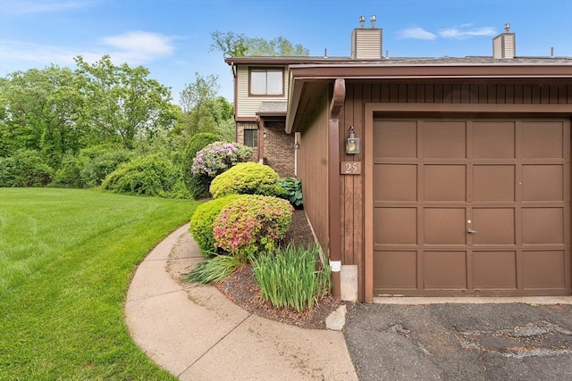 25 Ash Ln Unit 25, Agawam, MA 01001 - view of front facade with a chimney, a front lawn, a garage, and brick siding