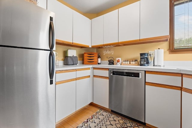 25 Ash Ln Unit 25, Agawam, MA 01001 - kitchen with stainless steel appliances, light countertops, light wood-style floors, and white cabinets