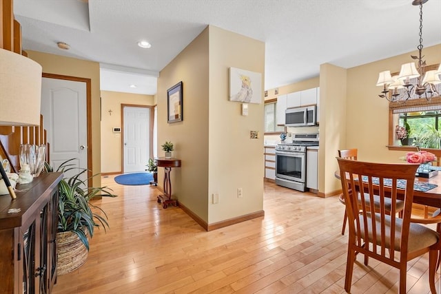 25 Ash Ln Unit 25, Agawam, MA 01001 - dining space with a chandelier, light wood-style flooring, baseboards, and recessed lighting