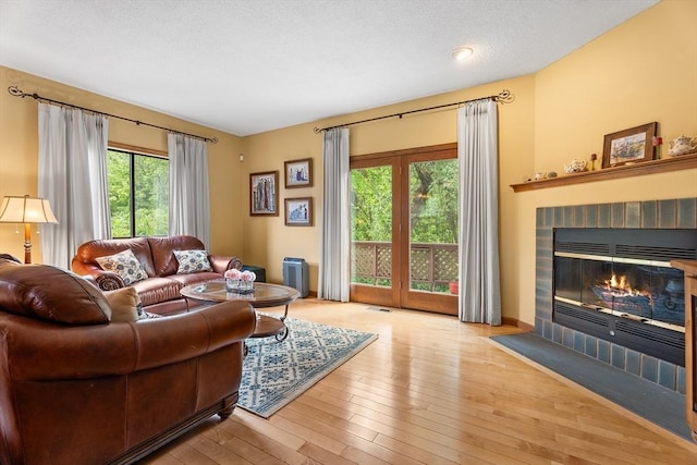 25 Ash Ln Unit 25, Agawam, MA 01001 - living area with plenty of natural light, a brick fireplace, and hardwood / wood-style floors