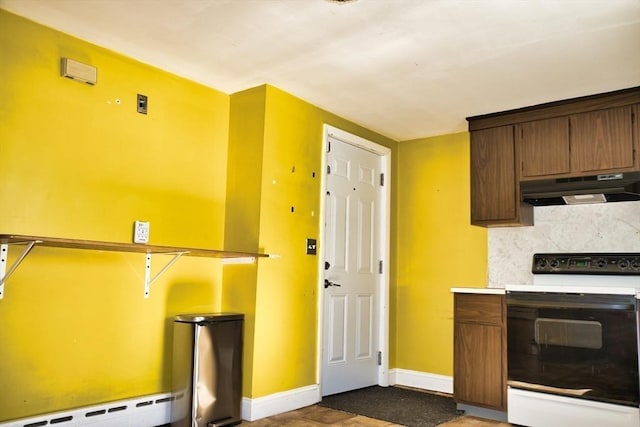 kitchen featuring baseboards, decorative backsplash, under cabinet range hood, a baseboard heating unit, and range with electric stovetop