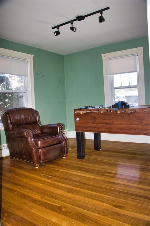 rec room featuring baseboard heating and wood finished floors