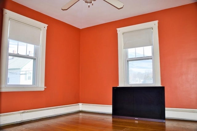 empty room with ceiling fan and wood finished floors