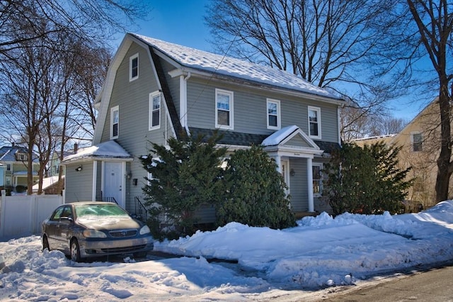 view of front of home featuring roof with shingles, fence, and a gambrel roof