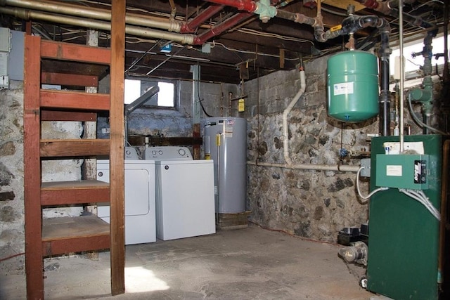 basement featuring water heater, independent washer and dryer, and a heating unit