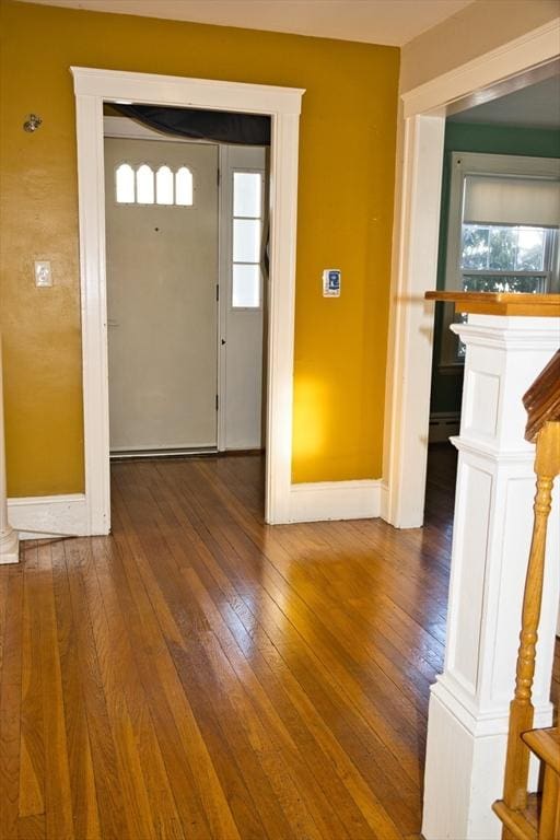 entrance foyer featuring baseboards, baseboard heating, and hardwood / wood-style floors