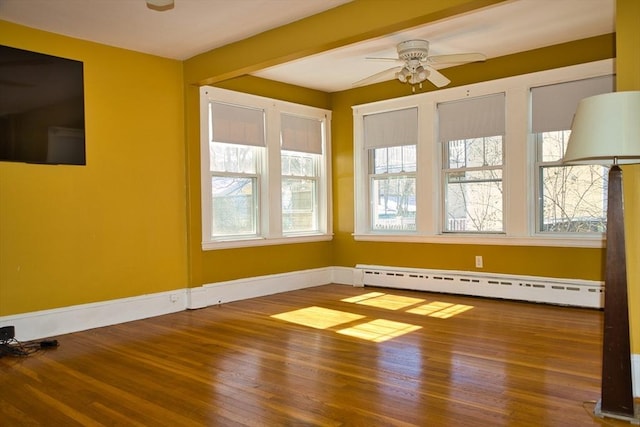 interior space with a ceiling fan and a baseboard radiator