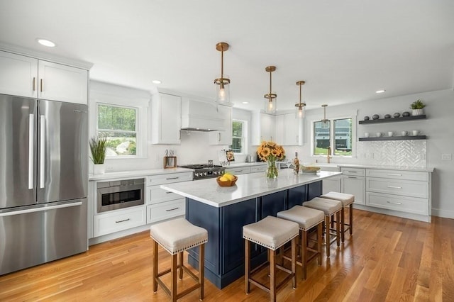 84 S St, Rockport, MA 01966 - kitchen featuring freestanding refrigerator, a kitchen bar, gas range, light countertops, and white cabinets