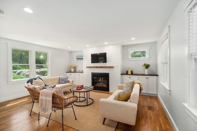 84 S St, Rockport, MA 01966 - living room featuring a fireplace, light wood-style flooring, plenty of natural light, baseboards, and recessed lighting