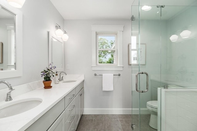 84 S St, Rockport, MA 01966 - bathroom with double vanity, toilet, a stall shower, baseboards, and tile patterned flooring