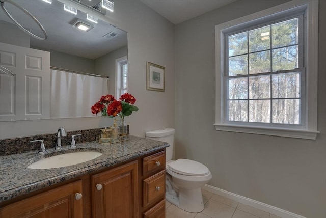 bathroom with visible vents, toilet, vanity, baseboards, and tile patterned floors