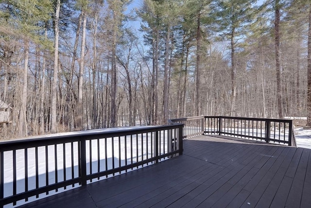 wooden terrace featuring a forest view