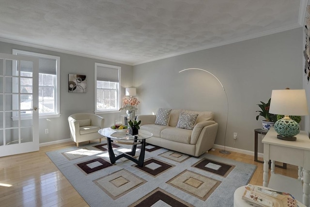 living room featuring baseboards, ornamental molding, arched walkways, and wood finished floors