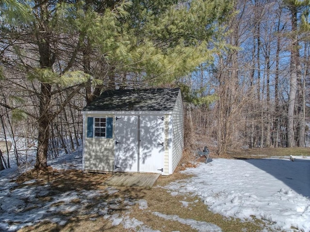 view of shed featuring a forest view