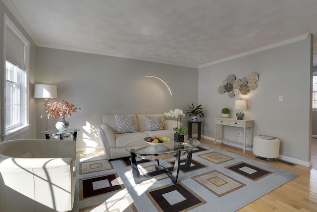 living room with baseboards, wood finished floors, and crown molding