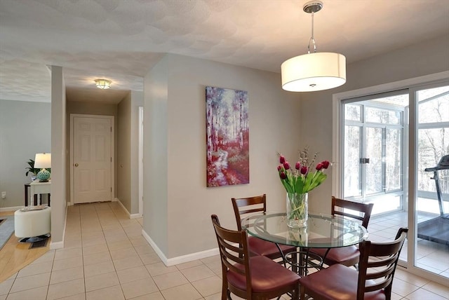 dining room featuring light tile patterned floors and baseboards