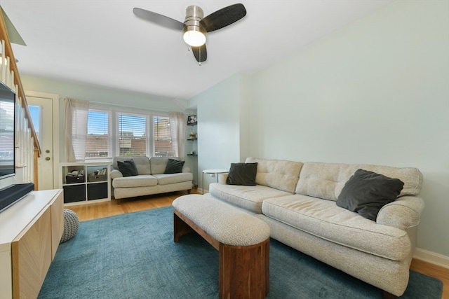 living room featuring light wood-type flooring and ceiling fan