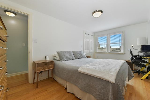 bedroom featuring a closet and light wood-type flooring