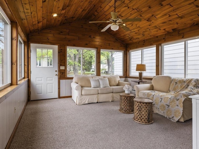 living room with wood walls, lofted ceiling, ceiling fan, wood ceiling, and carpet
