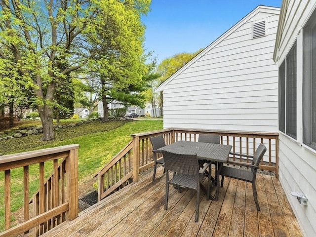 wooden deck featuring a yard and outdoor dining space