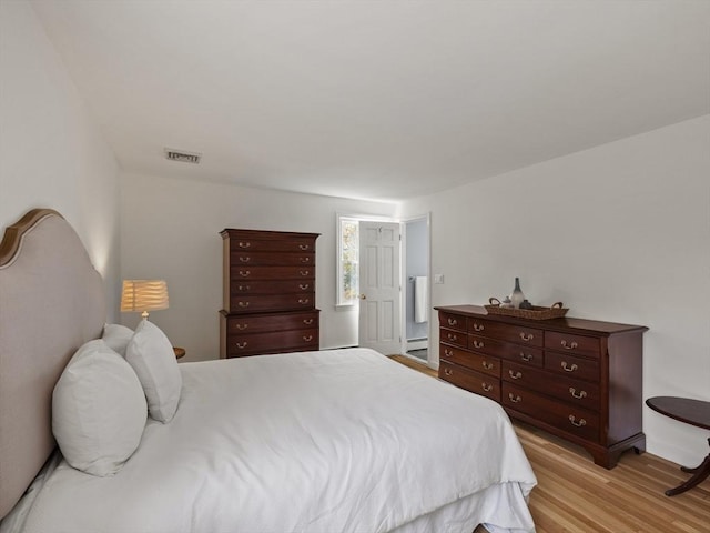 bedroom featuring visible vents and light wood-type flooring