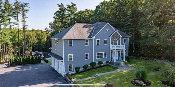 view of front of home featuring a garage and a front lawn