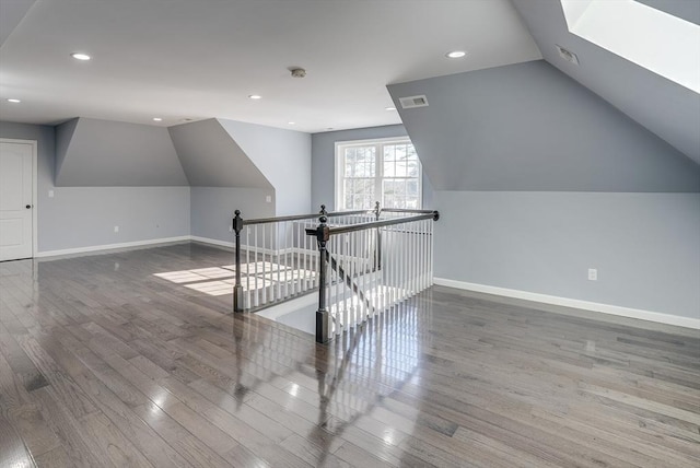 bonus room featuring hardwood / wood-style flooring and lofted ceiling