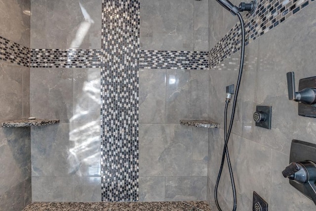 bathroom with tiled shower