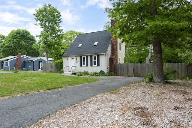 100 Kelley Rd, Barnstable, MA 02601 - view of front of house with board and batten siding, a chimney, roof with shingles, and driveway