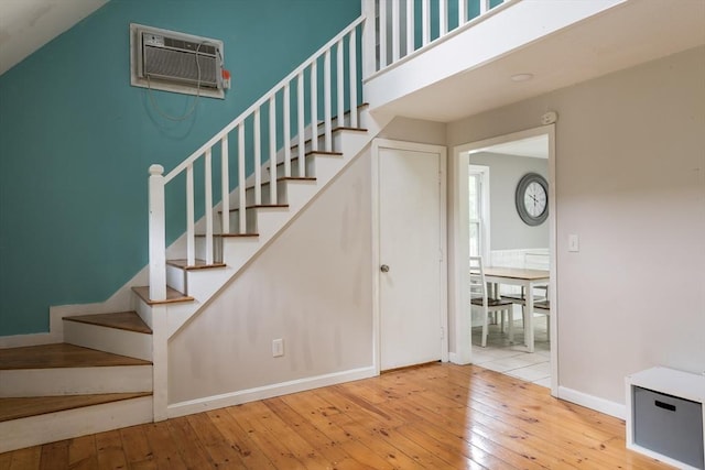 100 Kelley Rd, Barnstable, MA 02601 - stairs with a wall unit AC, hardwood / wood-style floors, and baseboards