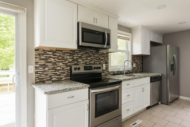 100 Kelley Rd, Barnstable, MA 02601 - kitchen featuring appliances with stainless steel finishes, a sink, tasteful backsplash, and white cabinetry