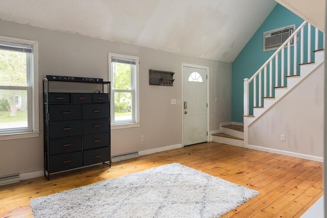 100 Kelley Rd, Barnstable, MA 02601 - entrance foyer with a wall mounted air conditioner, wood-type flooring, stairway, lofted ceiling, and baseboards