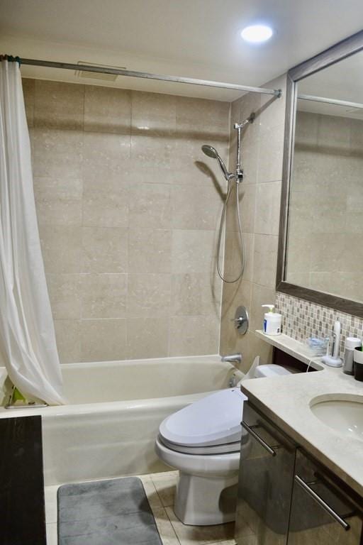 bathroom featuring shower / bath combo with shower curtain, toilet, decorative backsplash, vanity, and tile patterned floors