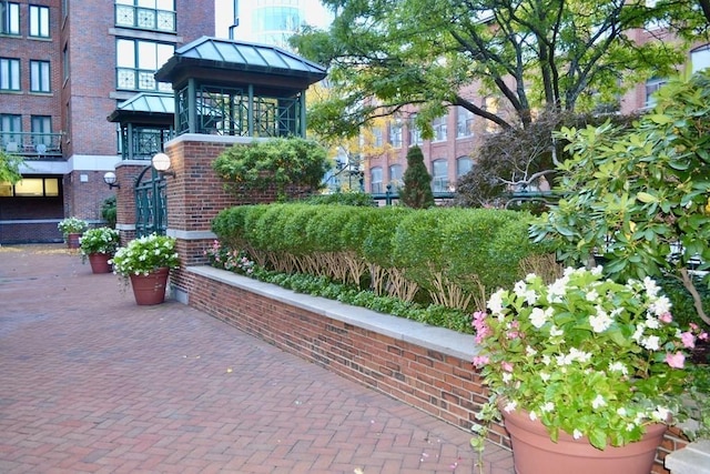property entrance featuring brick siding, a standing seam roof, and metal roof
