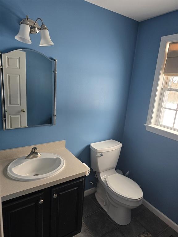 132 Bean Porridge Hill Rd, Westminster, MA 01473 - half bath featuring tile patterned floors, toilet, vanity, and baseboards