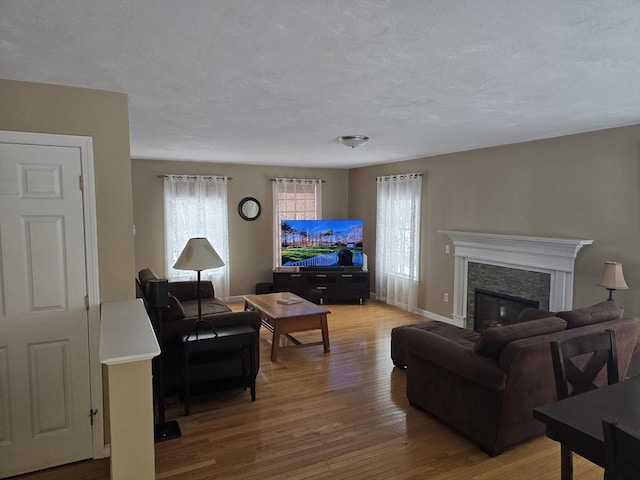 132 Bean Porridge Hill Rd, Westminster, MA 01473 - living area featuring light wood-style floors, a fireplace, baseboards, and a textured ceiling