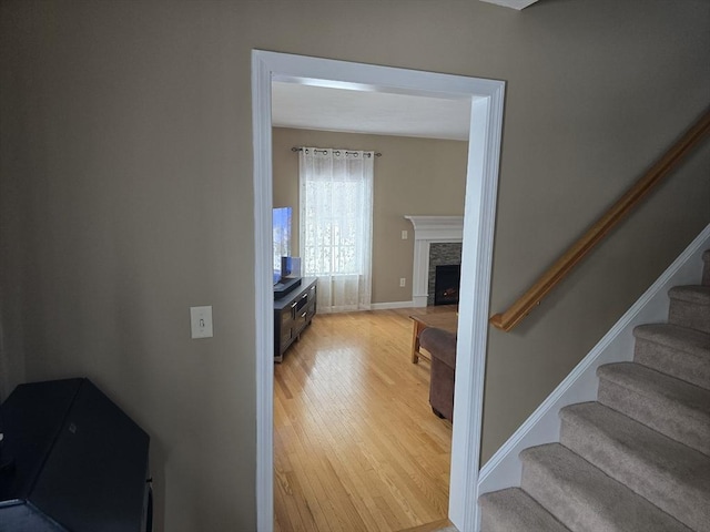 132 Bean Porridge Hill Rd, Westminster, MA 01473 - stairway featuring wood finished floors, a stone fireplace, and baseboards