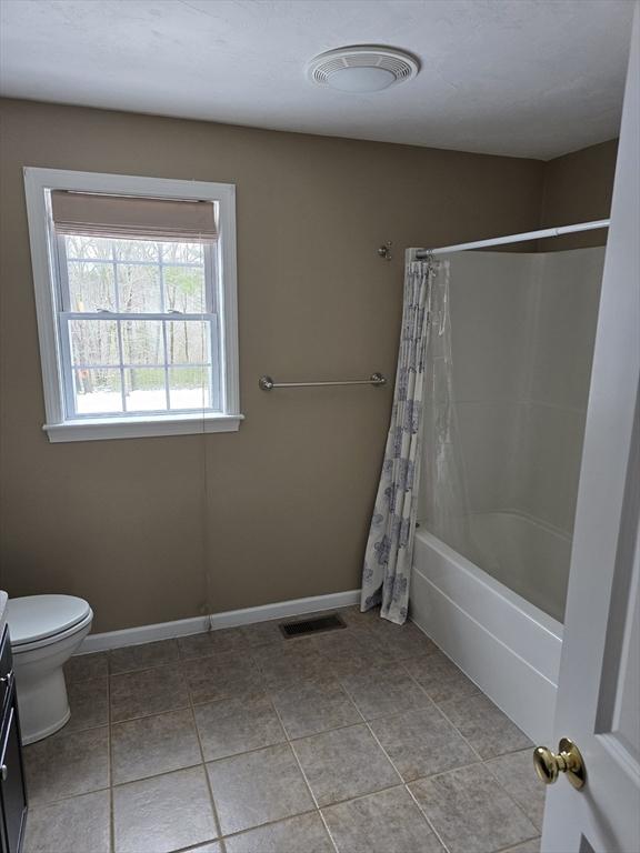 132 Bean Porridge Hill Rd, Westminster, MA 01473 - bathroom featuring vanity, toilet, tile patterned floors, and shower / bathtub combination with curtain