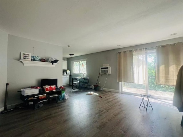 3 Fernview Ave Unit 11, North Andover, MA 01845 - living area with wood finished floors, baseboards, an AC wall unit, a desk, and a baseboard heating unit