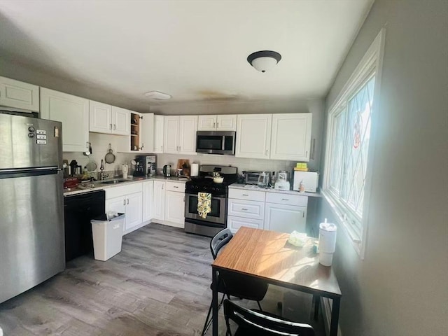 3 Fernview Ave Unit 11, North Andover, MA 01845 - kitchen with appliances with stainless steel finishes, a sink, white cabinets, and wood finished floors