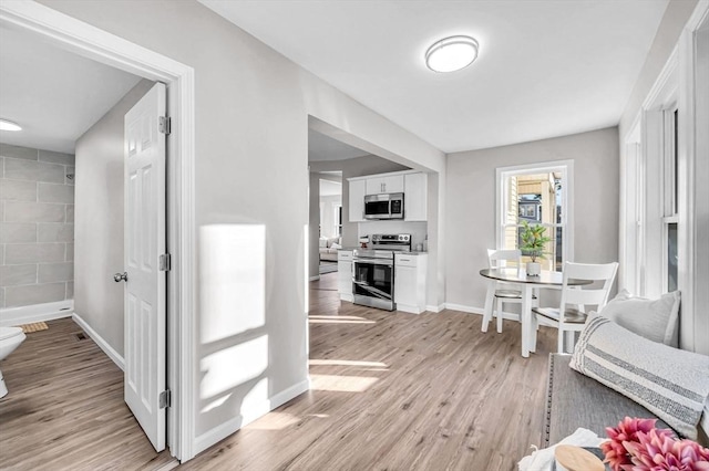 hall with light hardwood / wood-style floors