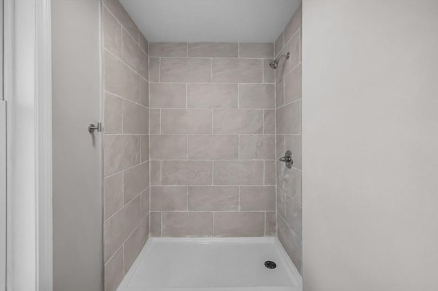 bathroom with tiled shower