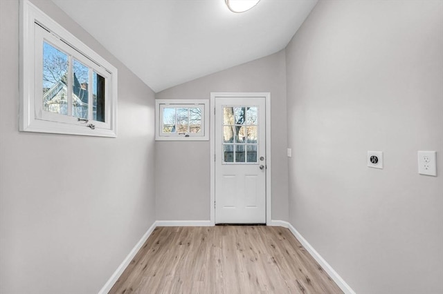 entryway with light hardwood / wood-style floors, a wealth of natural light, and lofted ceiling