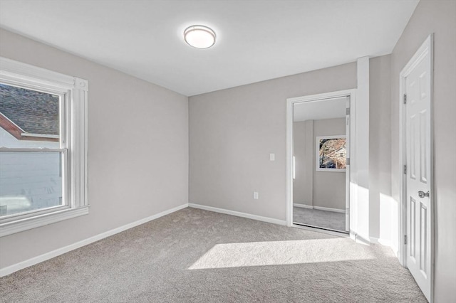 spare room with a healthy amount of sunlight and light colored carpet