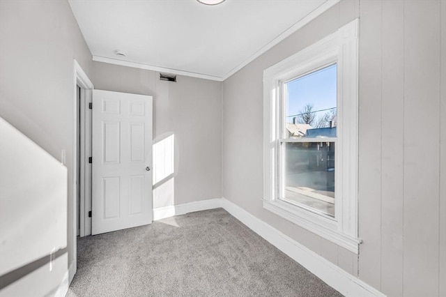 carpeted spare room featuring ornamental molding