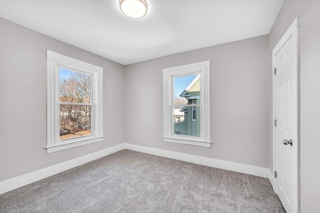 spare room featuring light carpet